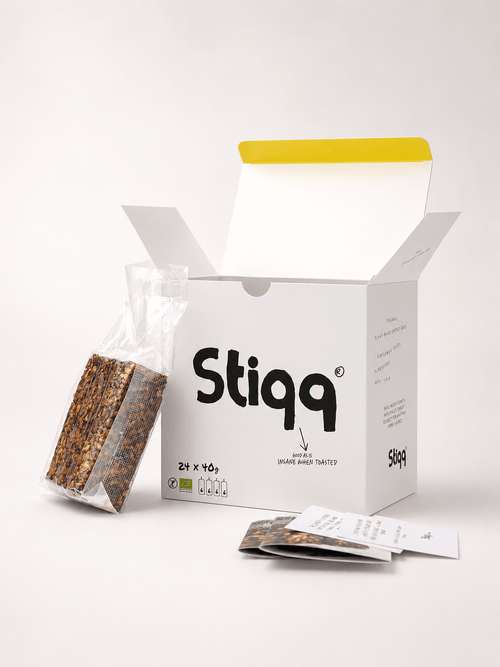 Stiqq 24-pack gluten-free savoury bars with opened box, wrapped bar, and product cards on a white studio background.