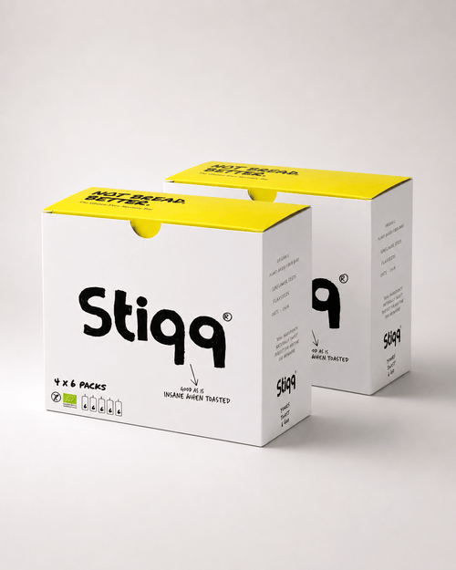Two Stiqq gluten free savoury bar product boxes with yellow tops and white packaging on a light gray background