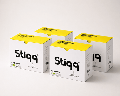 Stiqq gluten free savoury bar boxes displayed together with yellow lids and white packaging
